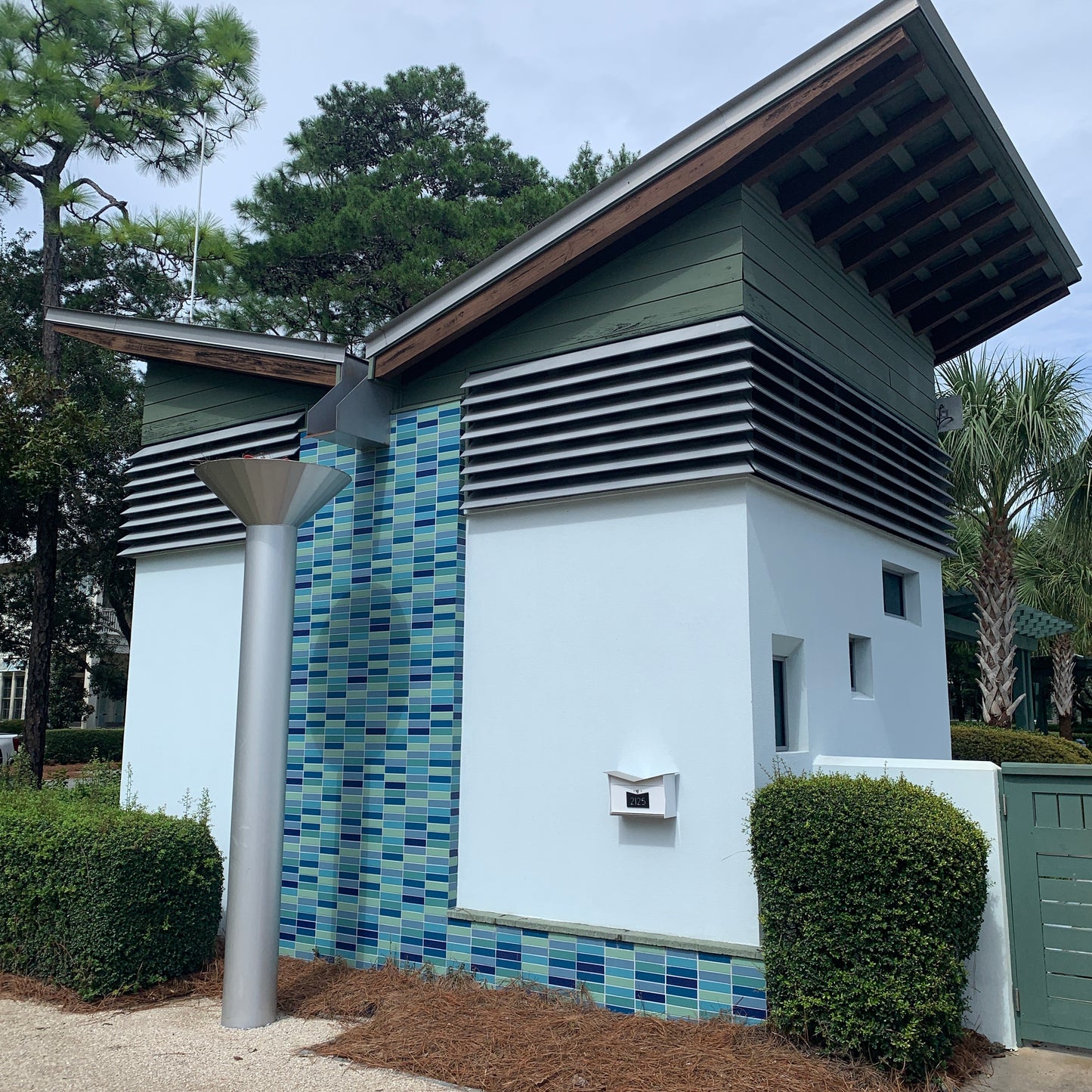 Wall Mount Mailbox mounted to outdoor wall. ButterFly Box in arctic white and jet black