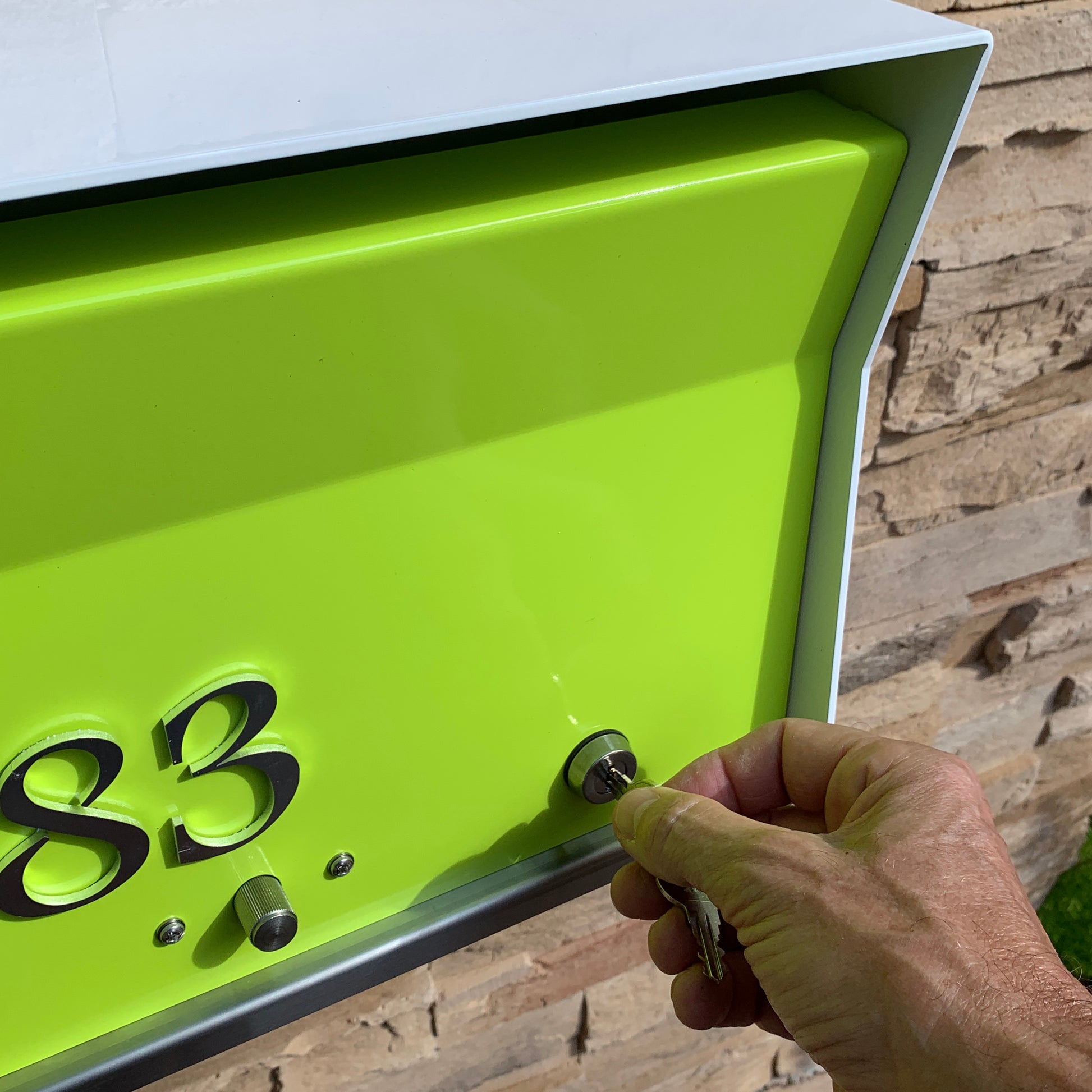 Wall Mount Mailbox mounted to outdoor wall. RetroBox in arctic white and lemon lime