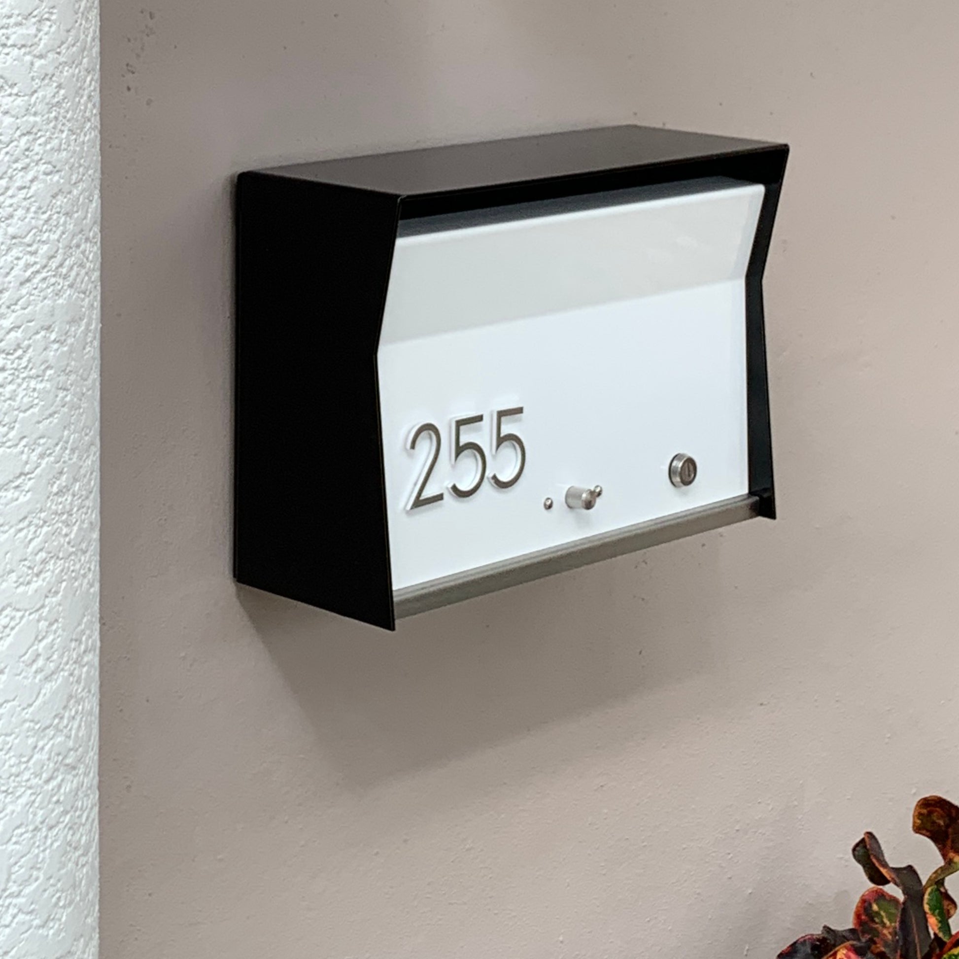 Wall Mount Mailbox mounted to outdoor wall. RetroBox in jet black and white