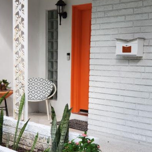 Wall Mount Mailbox mounted to outdoor wall. ButterFly Box in arctic white and orange