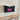 Wall Mount Mailbox mounted to outdoor wall. ButterFly Box in jet black and neon pink