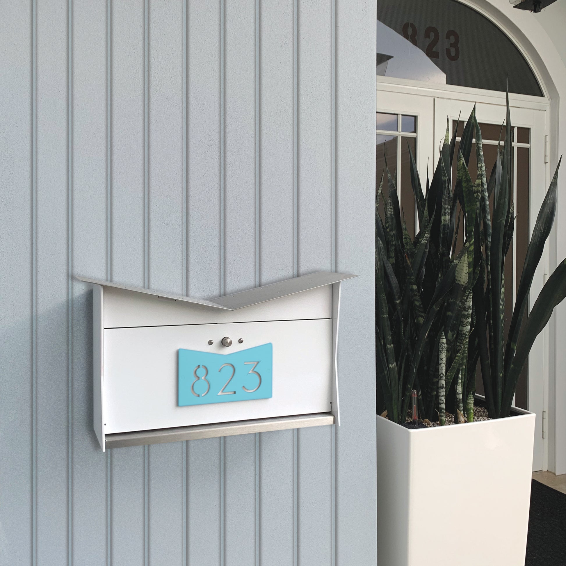 Wall Mount Mailbox mounted to outdoor wall. ButterFly Box in arctic white and sea foam