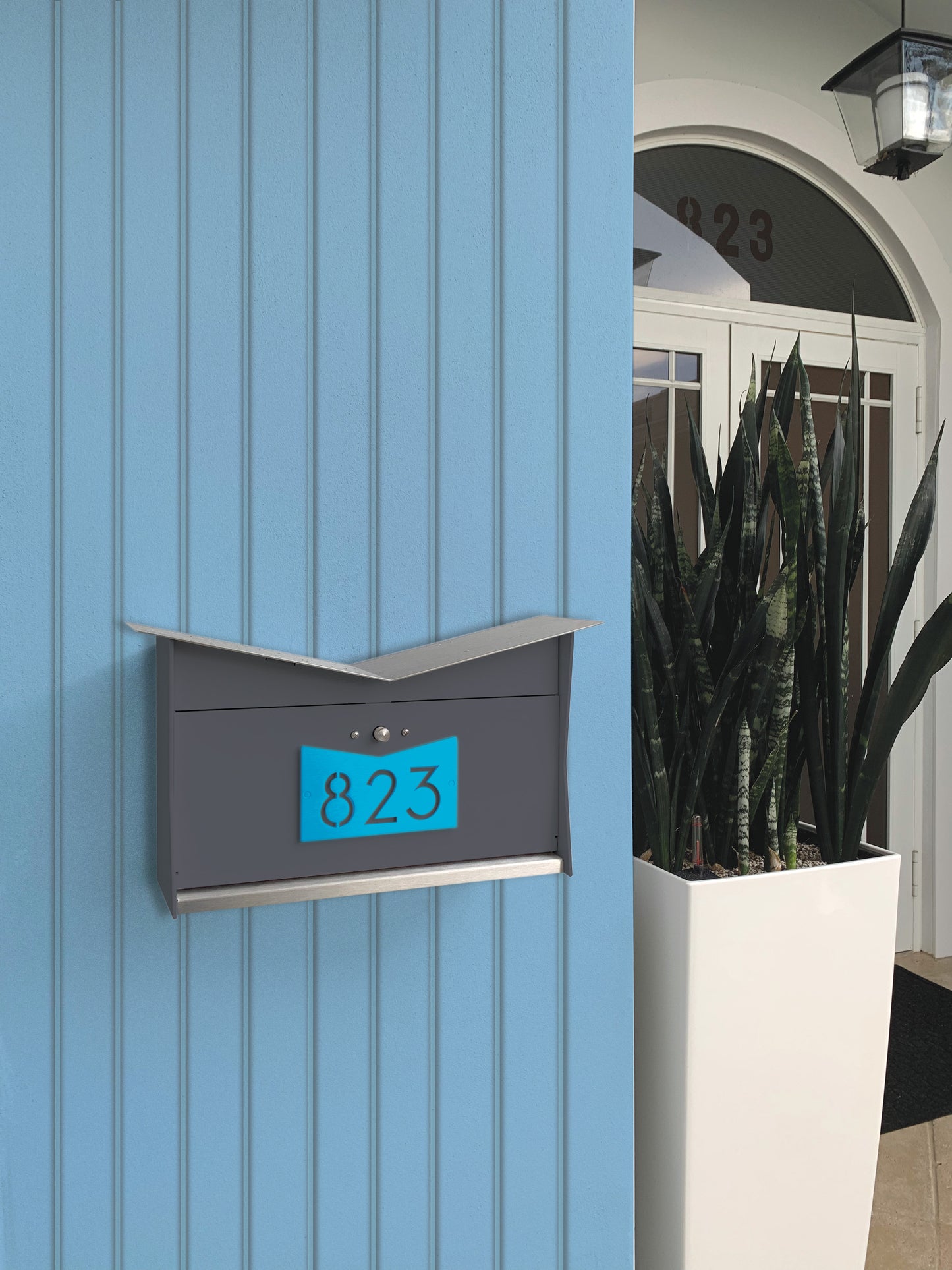 Wall Mount Mailbox mounted to outdoor wall. ButterFly Box in designer gray and aqua