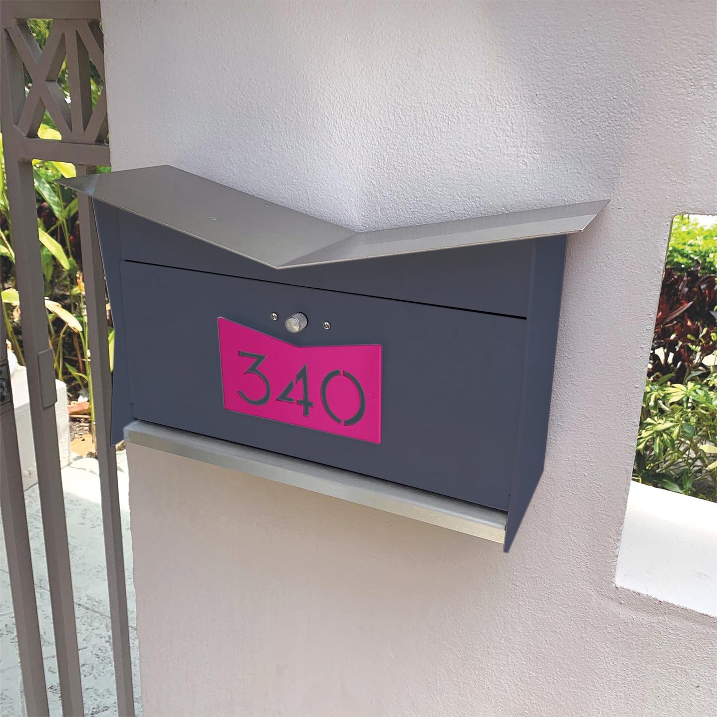 Wall Mount Mailbox mounted to outdoor wall. ButterFly Box in designer gray and neon pink