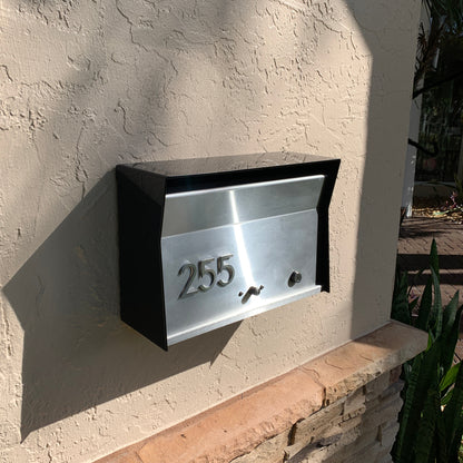 Wall Mount Mailbox mounted to outdoor wall. RetroBox in jet black and stainless steel