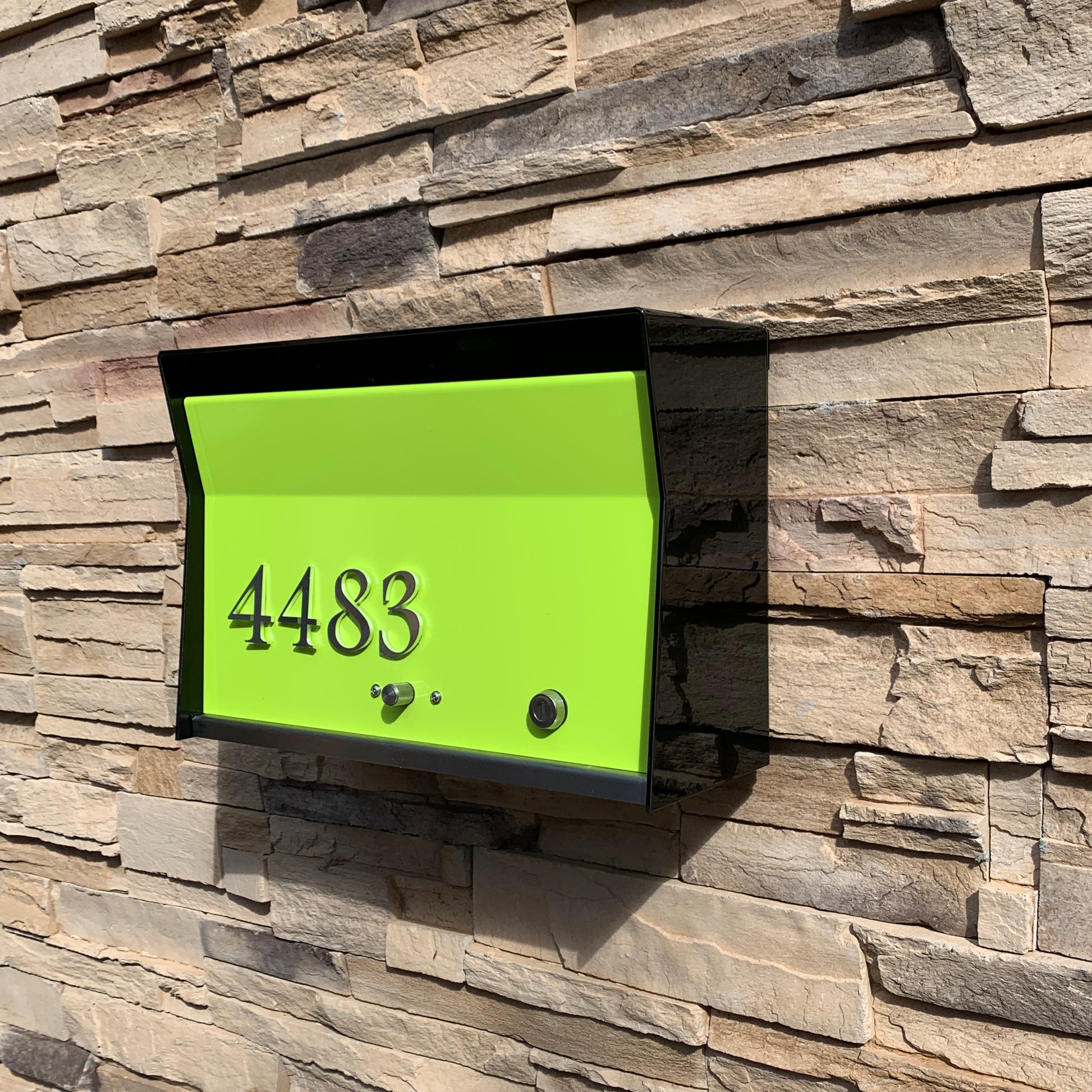 Wall Mount Mailbox mounted to outdoor wall. RetroBox in jet black and lemon lime