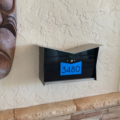 Wall Mount Mailbox mounted to outdoor wall. ButterFly Box in jet black and aqua