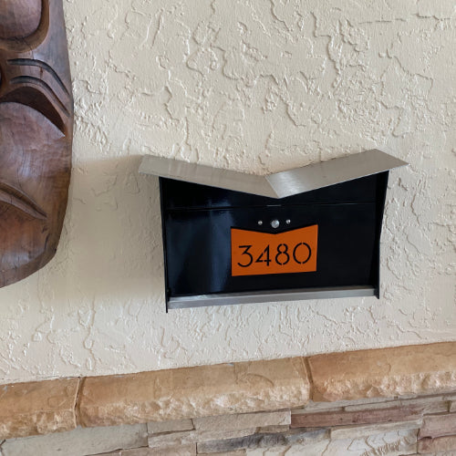 Wall Mount Mailbox mounted to outdoor wall. ButterFly Box in jet black and orange