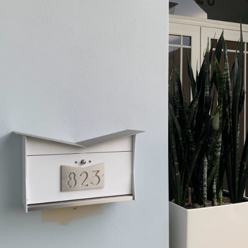 Wall Mount Mailbox mounted to outdoor wall. ButterFly Box in arctic white and stainless steel